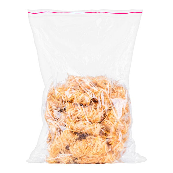 A clear plastic bag containing several light brown, shredded, twist-shaped items.