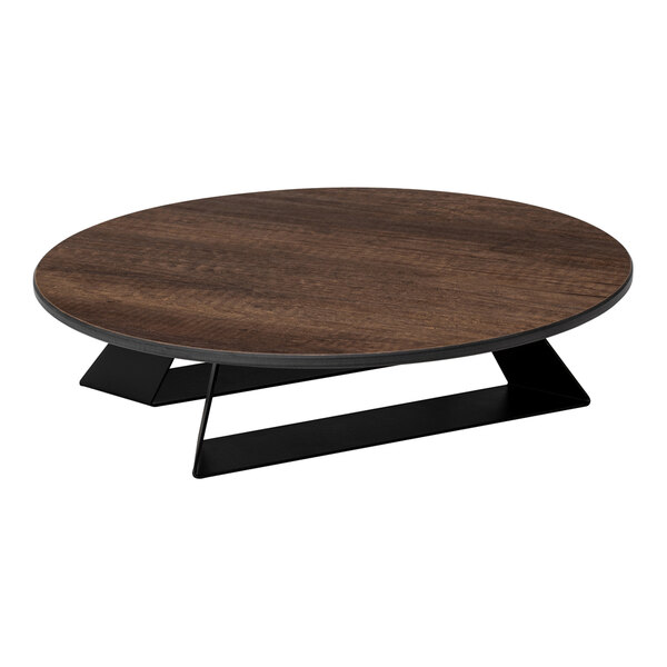 A round, low-profile riser with a dark wood-like top and black angled base.
