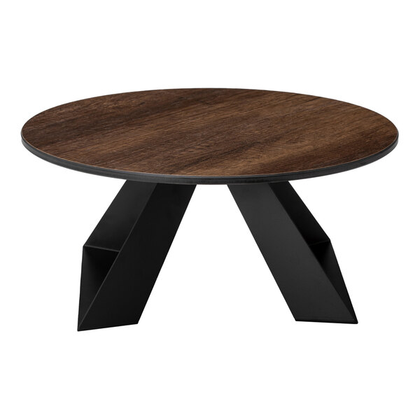 A round table with a dark wood-like top and black geometric legs.