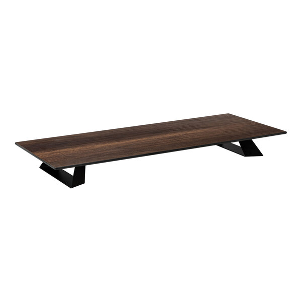 A low, rectangular platform with a dark wood-like surface and black angled legs.