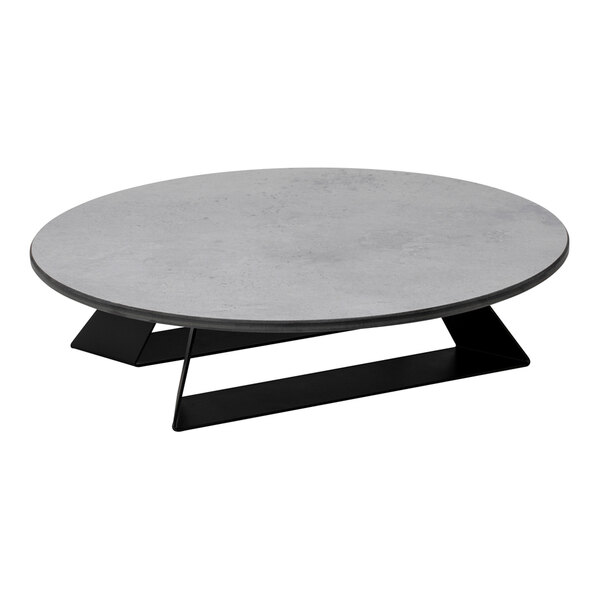 A round, low-profile riser with a concrete gray top and black angled base.
