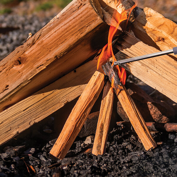 A bundle of natural fatwood fire starter sticks being lit to start a campfire.