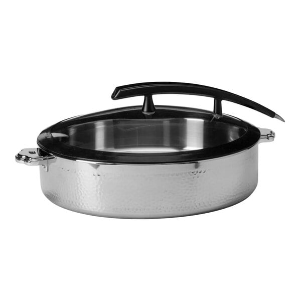 A round, hammered steel buffet server with a glass lid and a black handle.
