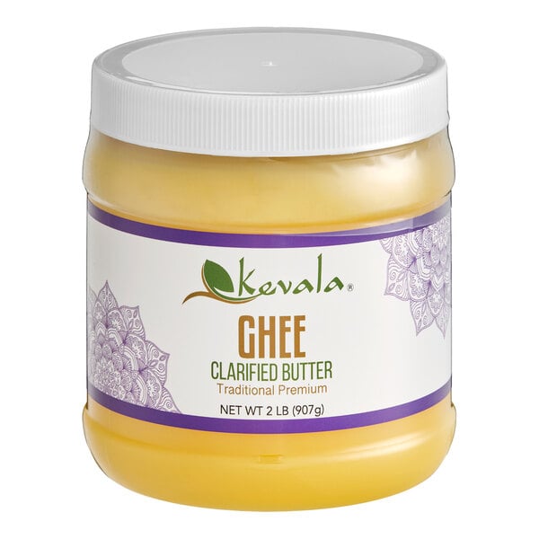 A plastic jar with a white lid containing yellow clarified butter, labeled as Kevala Ghee Clarified Butter, 2 lb (907g).