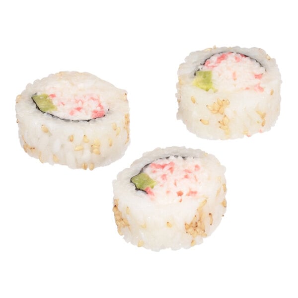 A set of three California sushi roll pieces with rice, imitation crab, avocado, and sesame seeds.