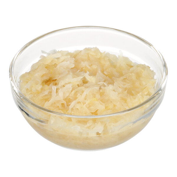 A clear glass bowl filled with shredded sauerkraut.