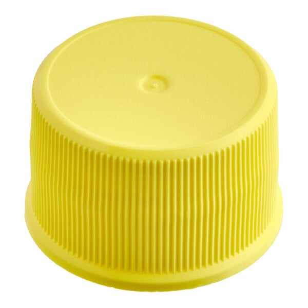 A yellow ribbed plastic cap with a smooth top and a circular indentation in the center.