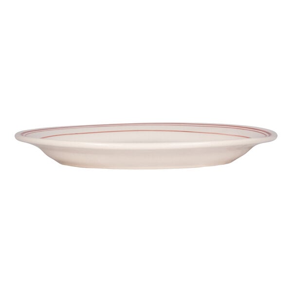 A white oval platter with red bands near the rim, shown from a side view.