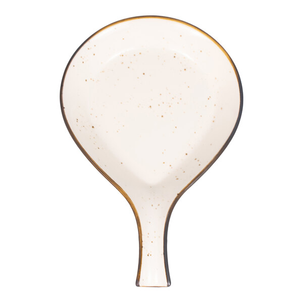 A cream-colored, speckled stoneware serving dish with a handle, shaped like a skillet.