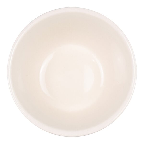 A top-down view of a plain, round, white bowl with smooth sides.