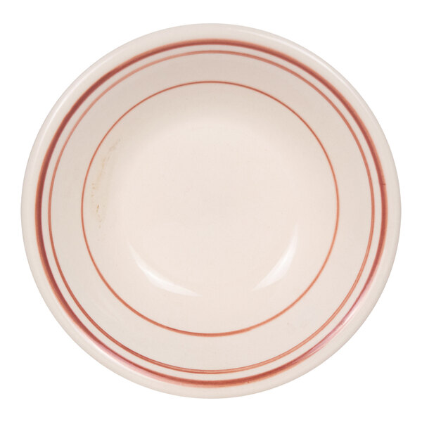 A round, white bowl with two red bands near the rim and one red band inside the bowl.