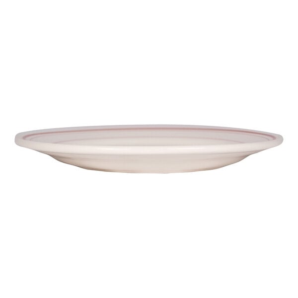 A round, shallow, white plate with a red band near the rim, viewed from the side.