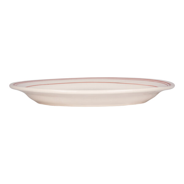 A white oval platter with red bands near the rim, shown from a side view.