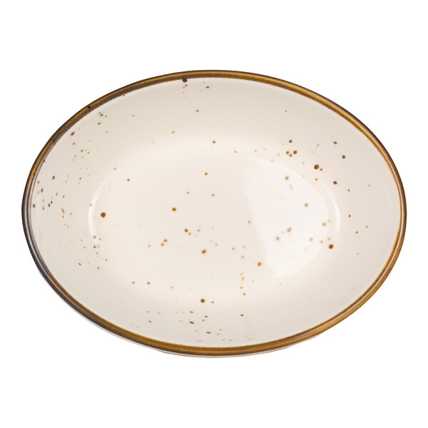 A cream-colored oval dish with brown speckles and a brown rim.