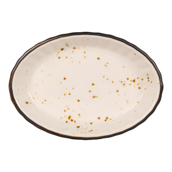 An oval-shaped, cream-colored dish with brown speckles and a dark, irregular rim.