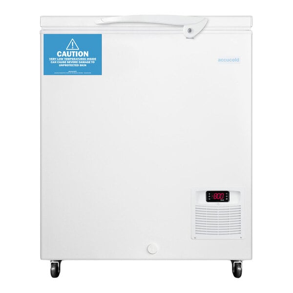 A white chest freezer with a digital temperature display, a caution label, and caster wheels at the bottom.