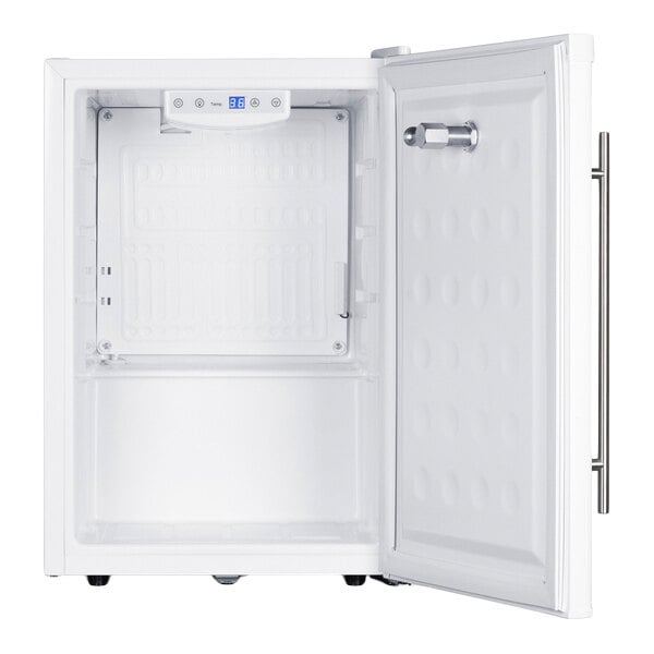 An open, empty white mini refrigerator or kegerator with a digital temperature display and a single tap on the door.