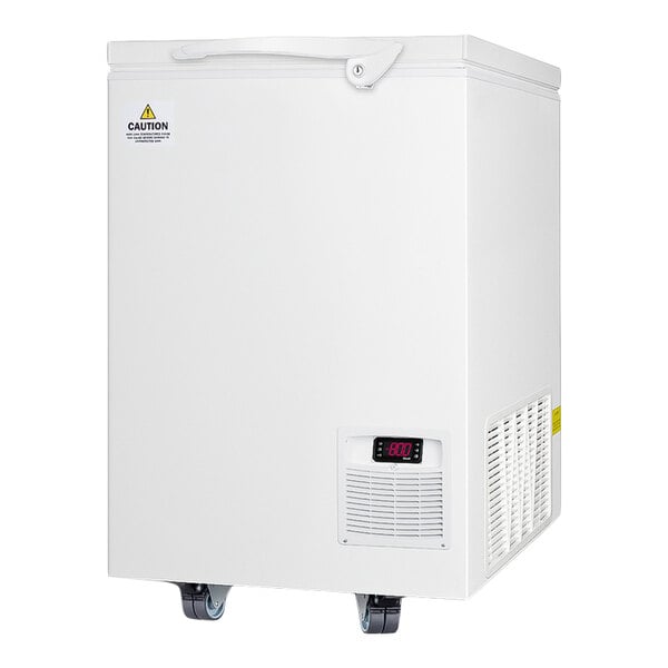 A white chest freezer with a digital temperature display, ventilation grilles, a caution label, and caster wheels at the bottom.
