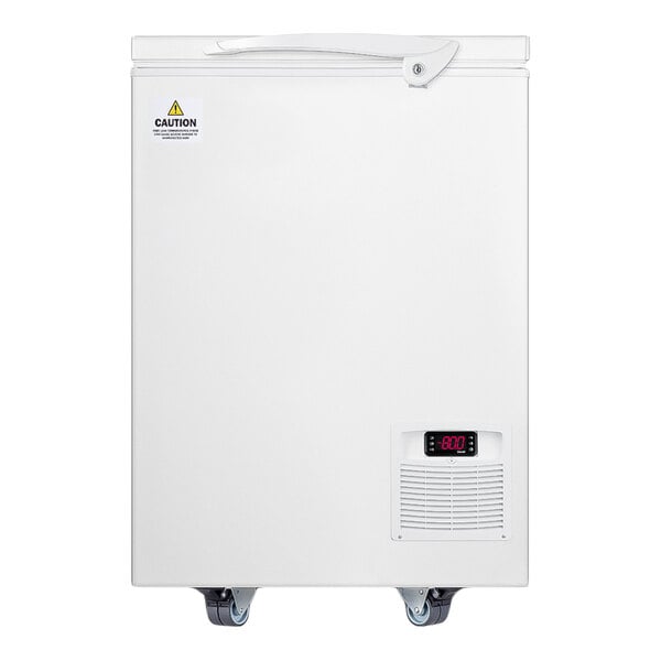 A white chest freezer with a digital temperature display, ventilation grill, and caster wheels at the bottom.
