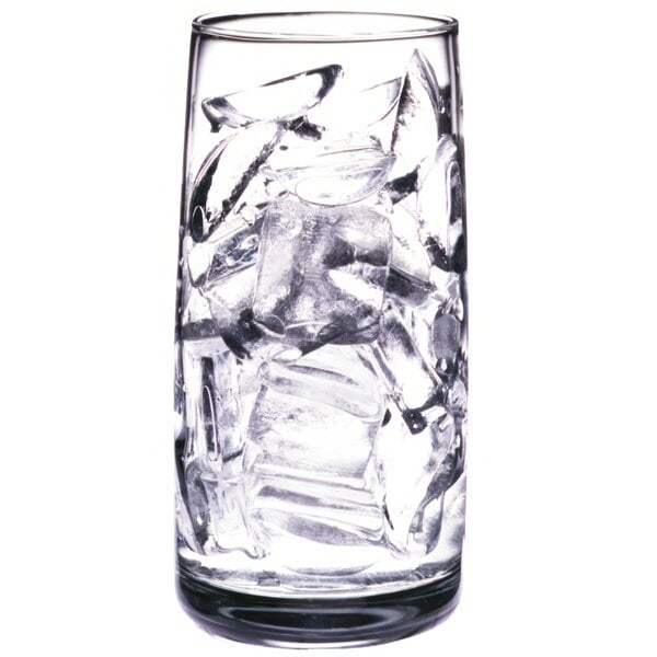 A clear glass filled with crescent-shaped ice cubes.