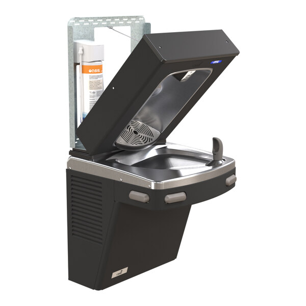 A wall-mounted drinking fountain with an open top section revealing internal components, including a water filter, and a bottle filler feature.