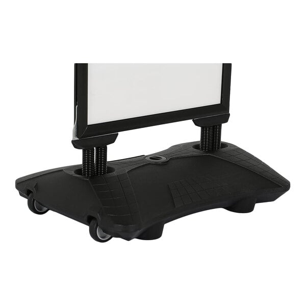A partial view of a black sign board with a sturdy base on wheels, featuring two support posts and a rectangular frame.