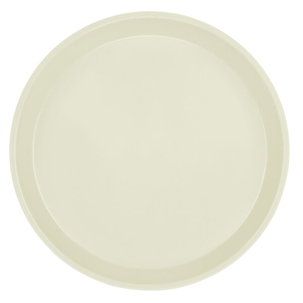 A close-up of a round white Cambro tray with a round rim.