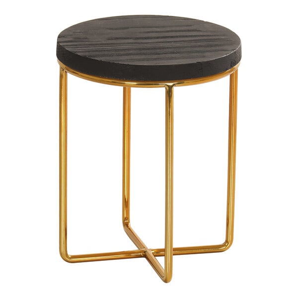 A small round table with a black textured top and a gold metal wire frame base.