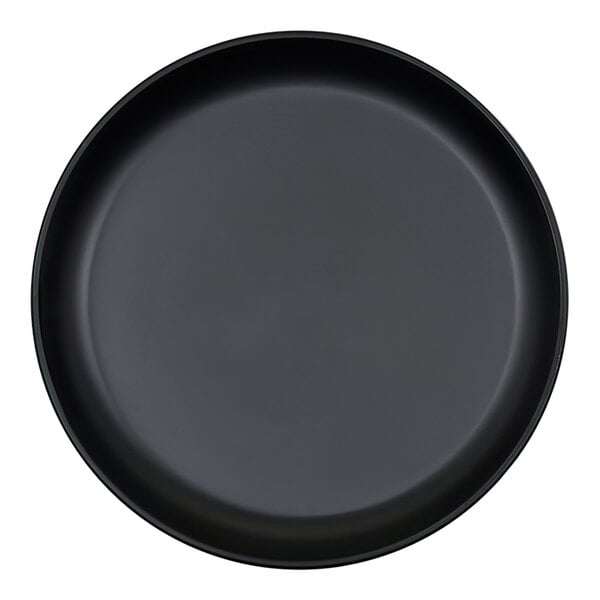 A black, round plate with a raised rim, viewed from above.