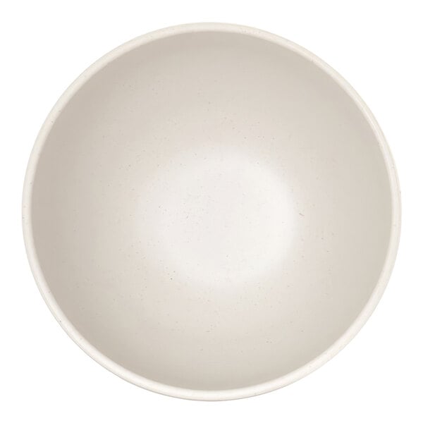 A top-down view of a plain, round, ivory-colored bowl with a smooth interior surface.