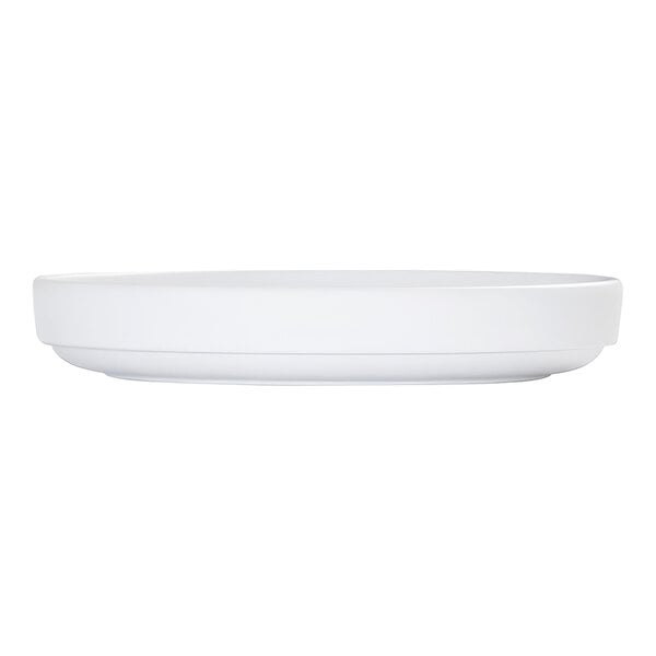 A white, round plate with a raised rim, shown from a side view against a plain background.