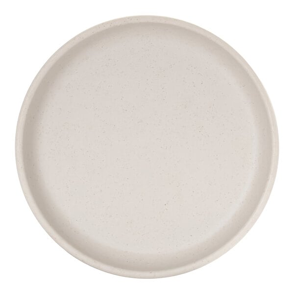 A round, ivory-colored plate with a raised rim and subtle speckled pattern.