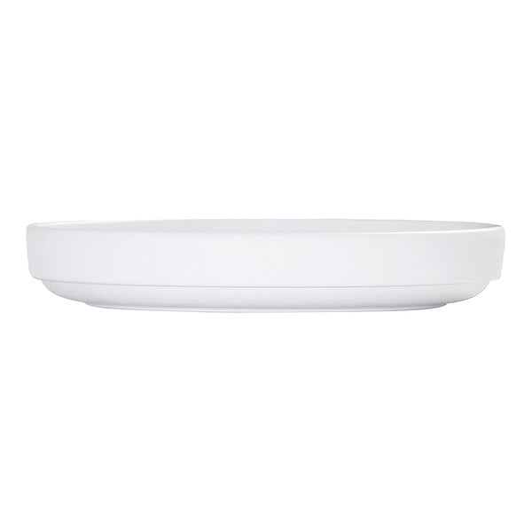 A white, round plate with a raised rim, shown from a side view against a plain background.