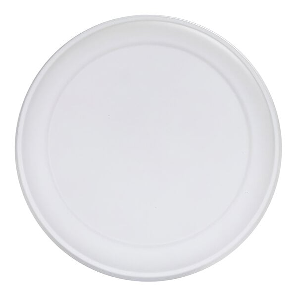 A plain, round, white plate with a slightly raised rim, viewed from above.
