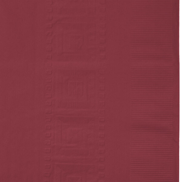 A burgundy table cover with square and square designs.