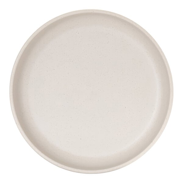 A round, ivory-colored plate with a raised rim and subtle speckled pattern.