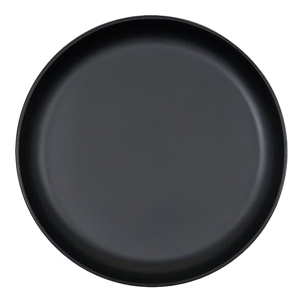 A round, black plate with a raised rim, viewed from above.