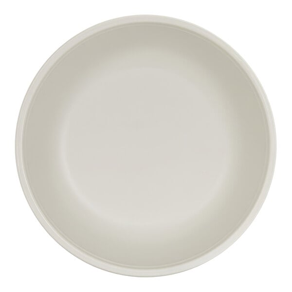 A top-down view of a plain, round, ivory-colored bowl.