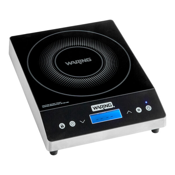 A black and silver countertop induction range with a digital display and touch controls, featuring a circular cooking zone on top.
