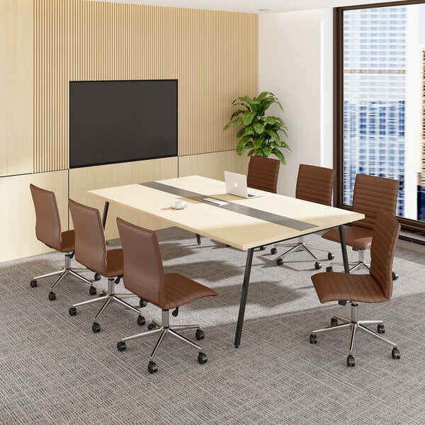 A modern conference room with six brown armless office chairs on casters arranged around a rectangular light wood table, with a large screen on the wall and a potted plant in the corner.