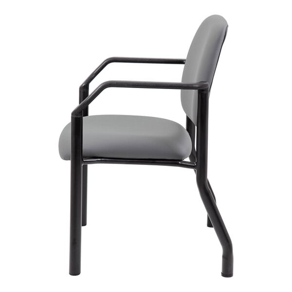 A side view of a chair with a gray cushioned seat and backrest, black metal frame, and armrests.