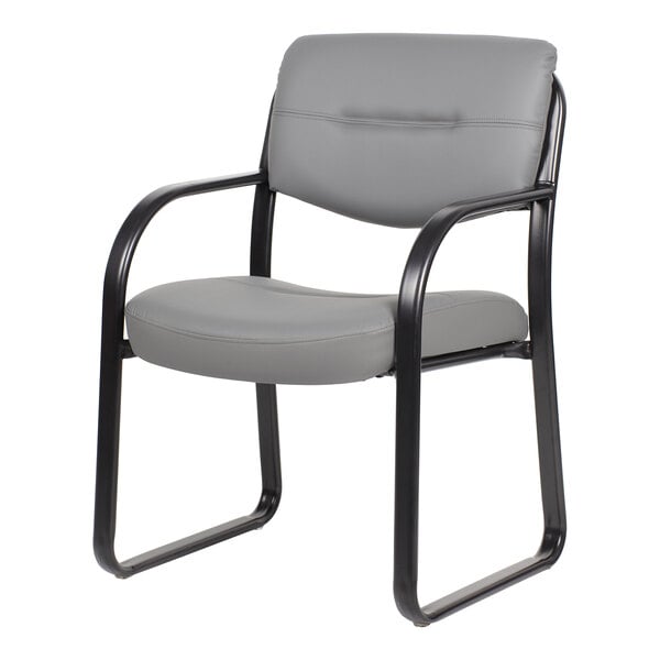 A gray cushioned chair with a sled base and black metal frame, featuring armrests and a padded backrest.