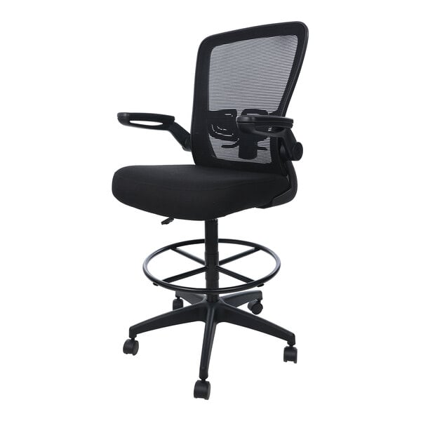 A black drafting stool with a mesh back, cushioned seat, flip-up armrests, circular footring, and five caster wheels.