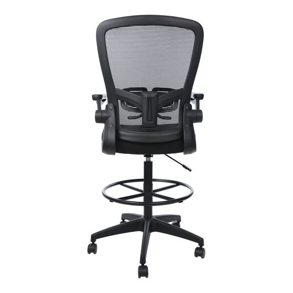 A black mesh-back drafting stool with flip-up arms, a circular footring, and a wheeled base, shown from the rear.