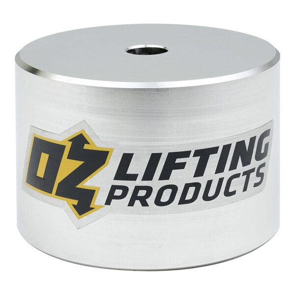 A cylindrical metallic object with a central hole on top and a label reading 'OZ Lifting Products' on the side.