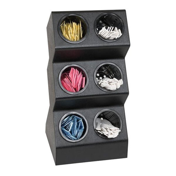 A black, three-tiered organizer with six round compartments, each holding different colored packets or items.