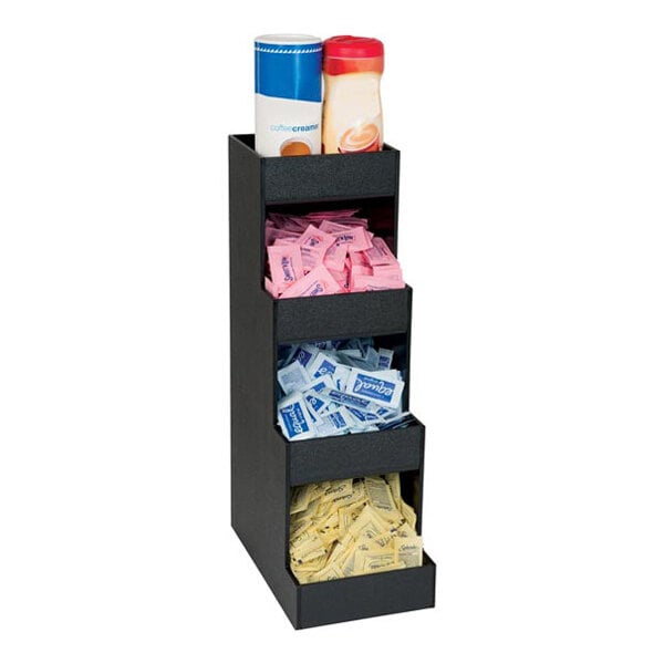 A black vertical organizer with four sections holding coffee creamers and assorted sweetener packets.