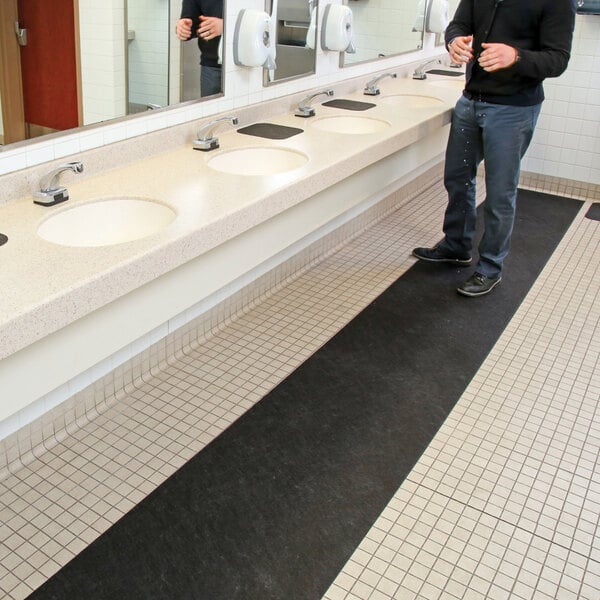 New Pig Grippy GRP7004-BK 2' x 25' Black Medium-Weight Antimicrobial Restroom Runner Mat with Adhesive Backing