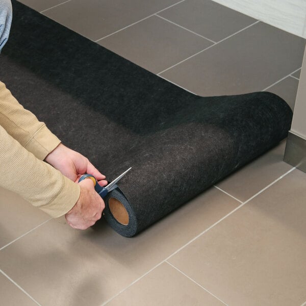 New Pig Grippy GRP7004-BK 2' x 25' Black Medium-Weight Antimicrobial Restroom Runner Mat with Adhesive Backing