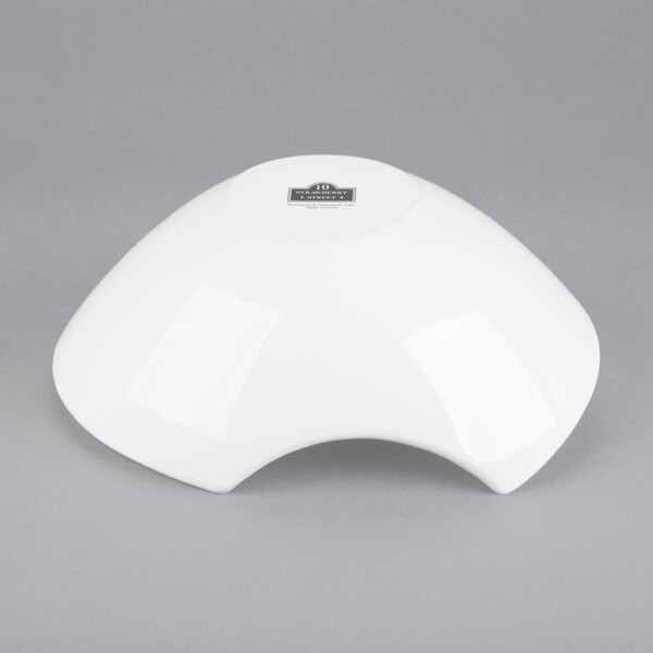 A 10 Strawberry Street Whittier white porcelain samurai bowl with a curved top on a gray surface.